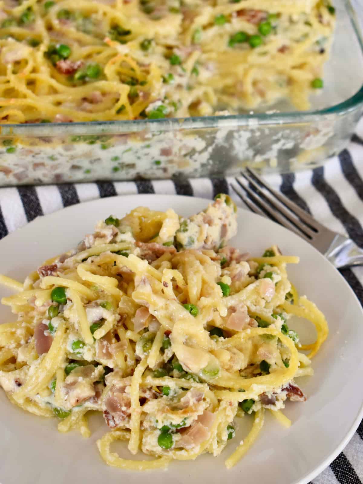 Baked Spaghetti with ricotta, bacon, and peas.