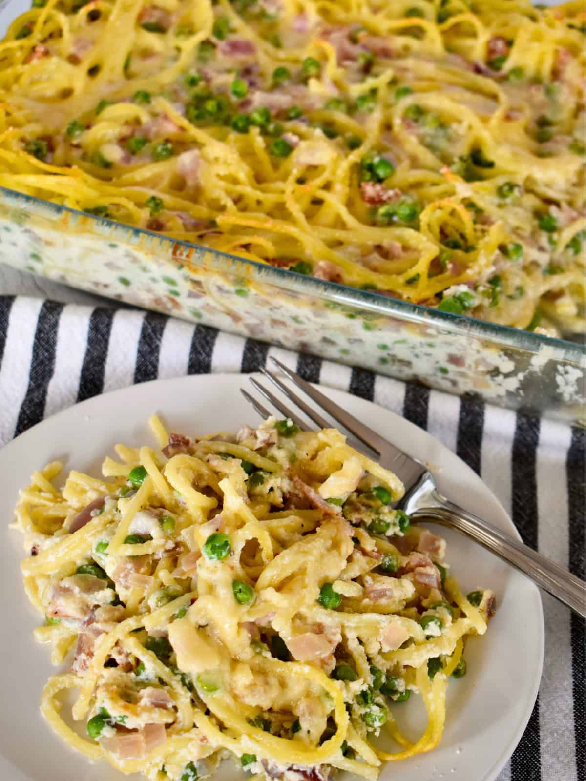 Baked spaghetti with ricotta, bacon, and peas.