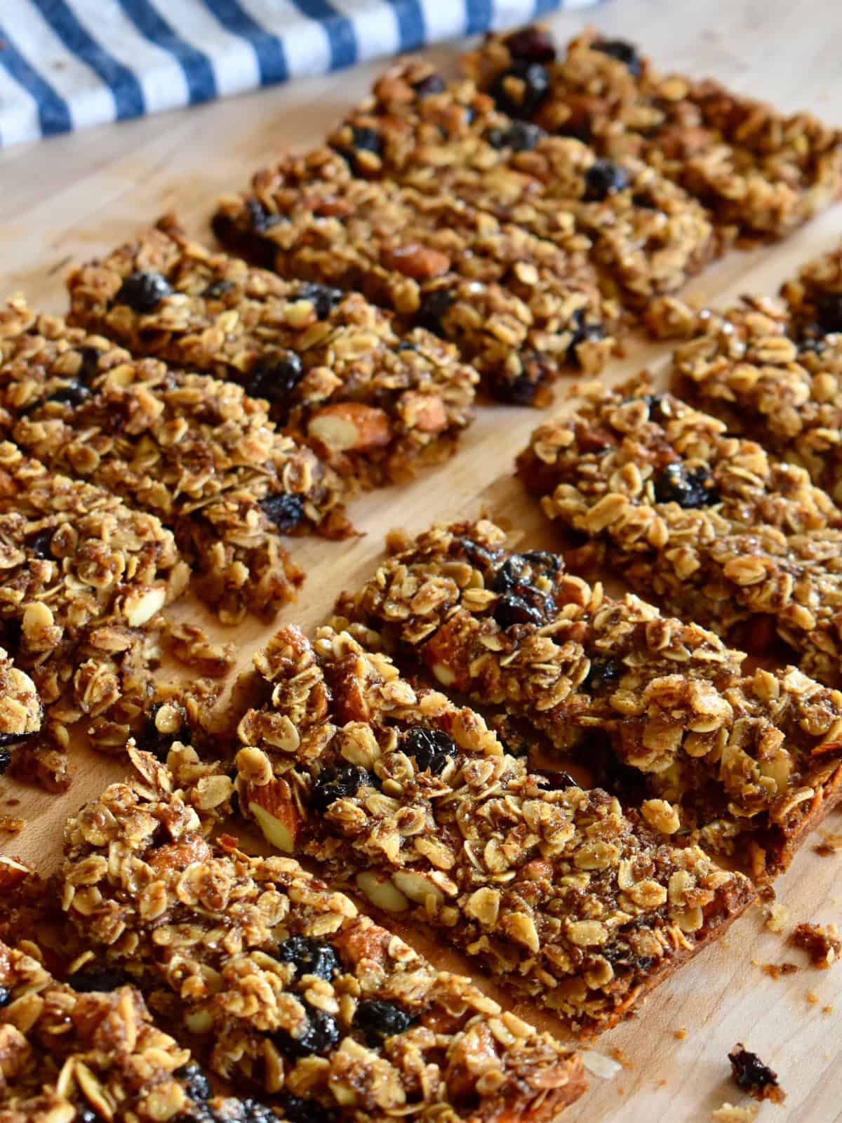 Cranberry Granola Bars with almonds on a cutting board.