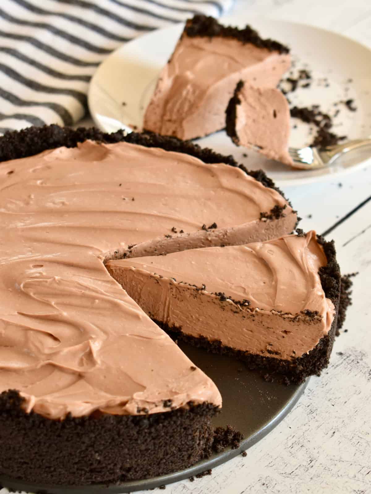 No Bake Chocolate Cheesecake in a springform pan with a slice missing from it.