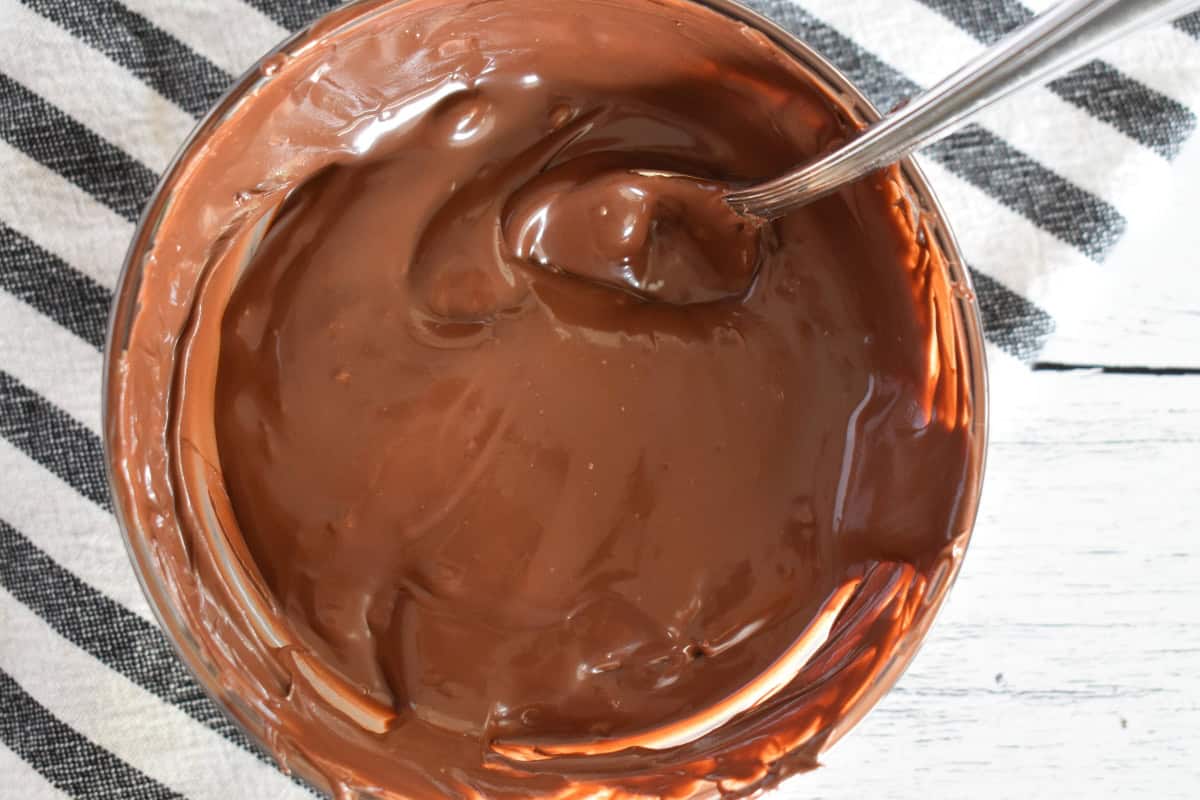 Melted chocolate in a bowl with a spoon.