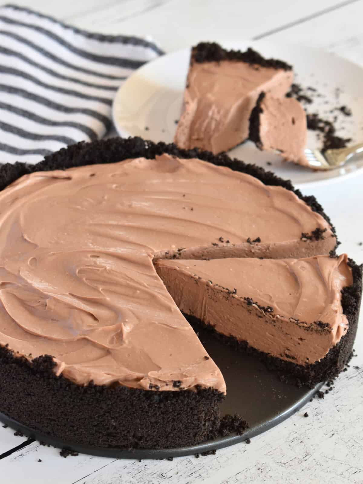 No Bake Chocolate Cheesecake in a pan with a slice missing.