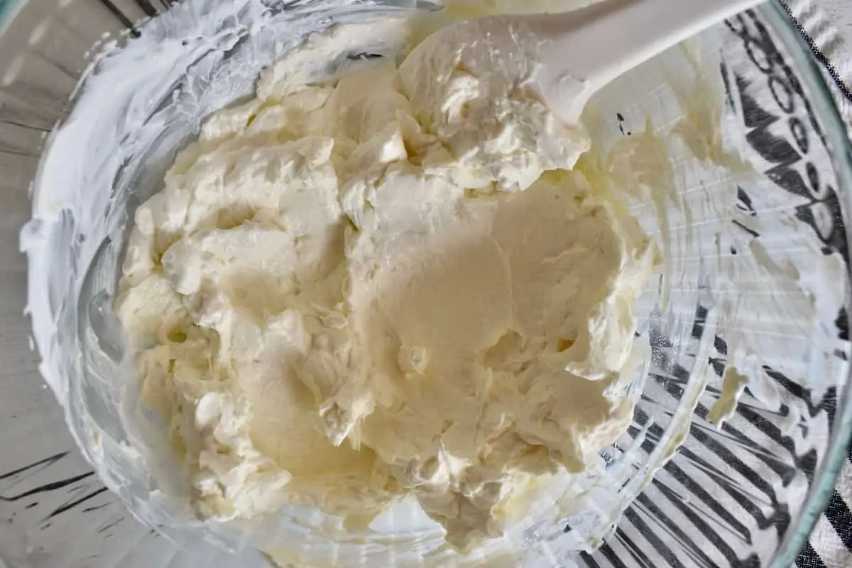 Cream cheese and sour cream mixed together in a bowl.
