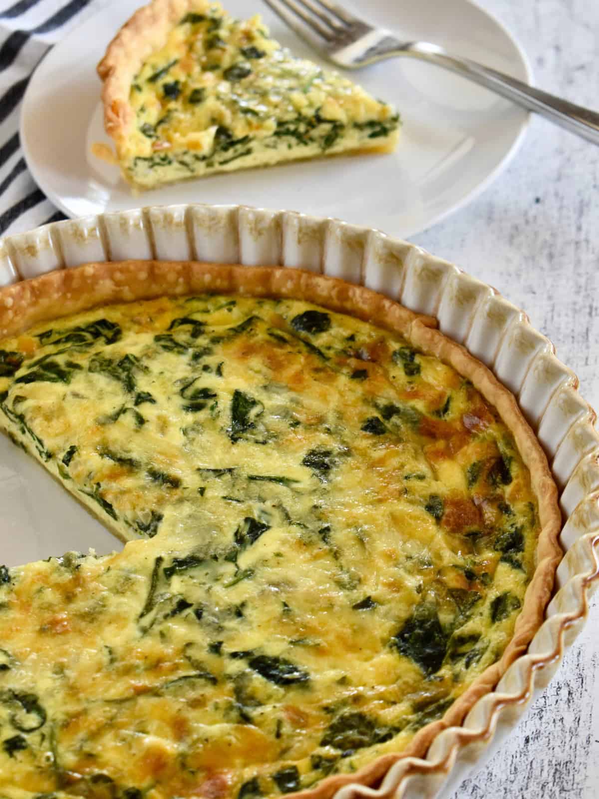 Spinach Gruyere Quiche in a pie plate. 