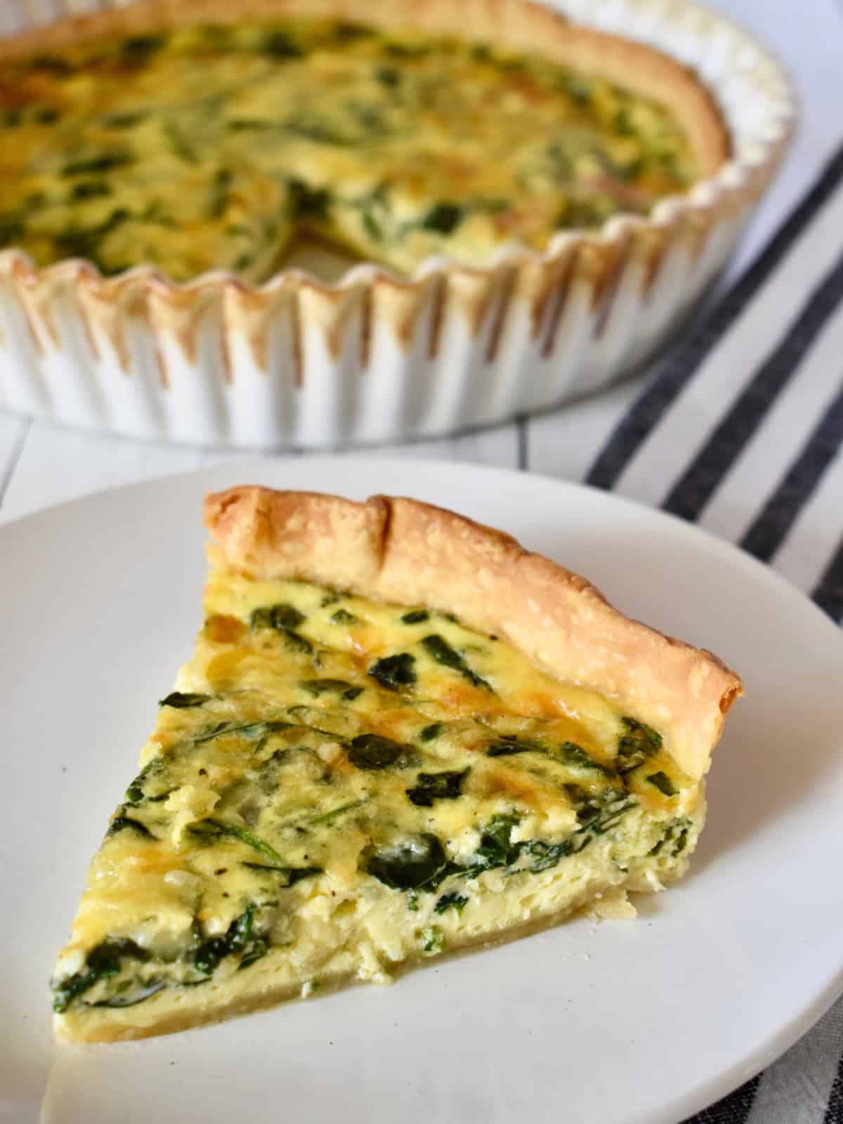 Spinach Gruyere Quiche on a white plate. 