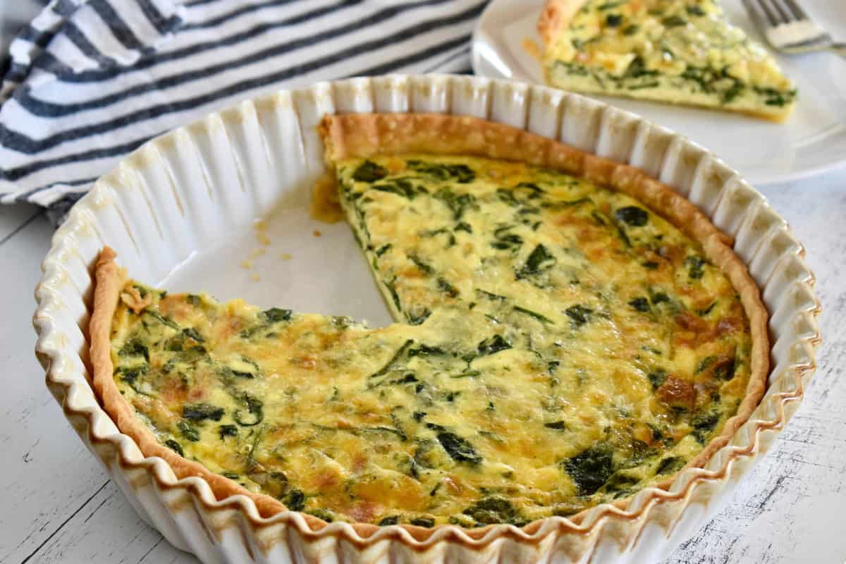 Spinach Gruyere Quiche with store bought pie crust in a pie dish. 