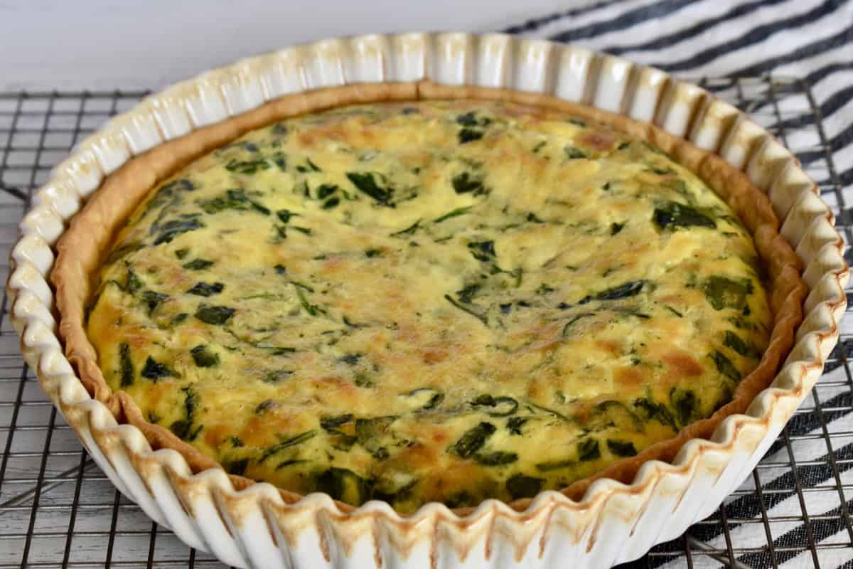 Spinach Gruyere Quiche on a wire cooling rack. 