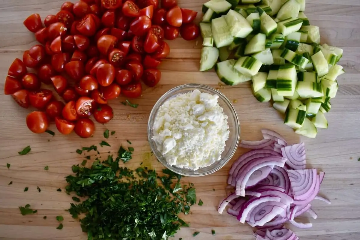 Chopped veggies for recipe on a cutting board.