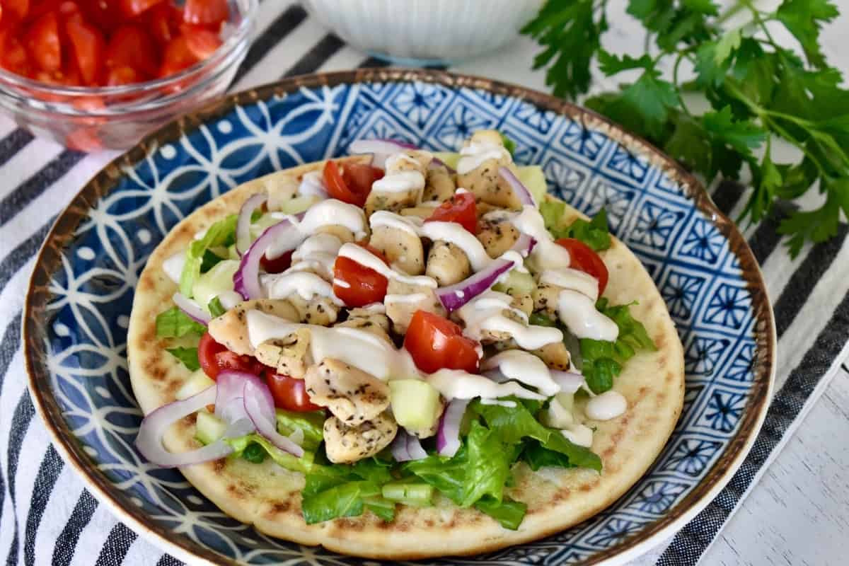 Greek Chicken Pitas on a blue plate.