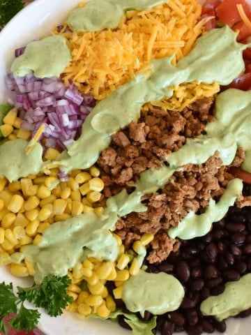 Ground Turkey Taco salad with avocado dressing.