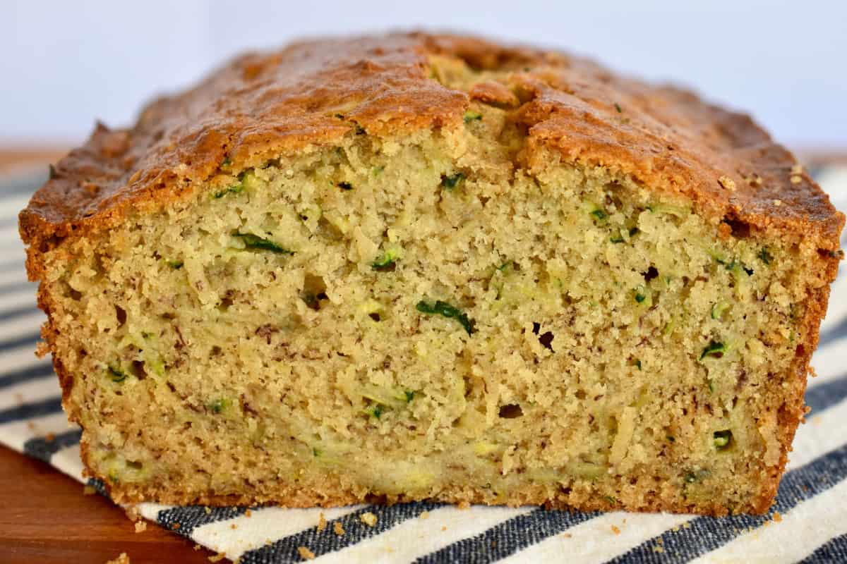 Zucchini Banana Bread loaf cut in half on a countertop.