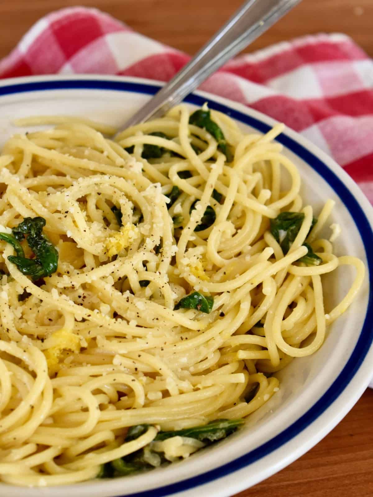 Lemon mascarpone pasta in a white bowl with a fork. 