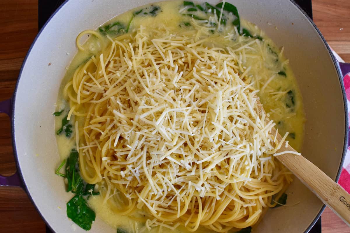 Spaghetti and parmesan cheese added to the skillet with the sauce. 