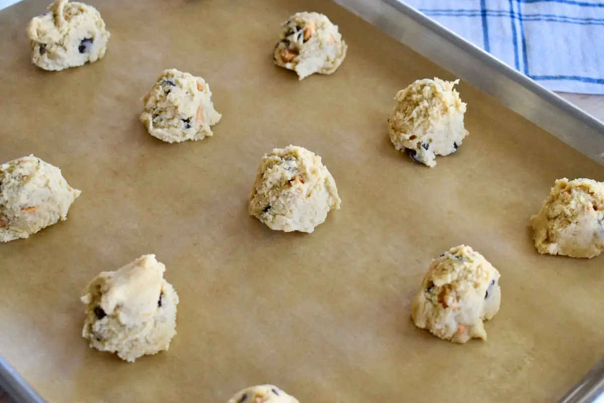 Dough balls on a lined baking sheet. 