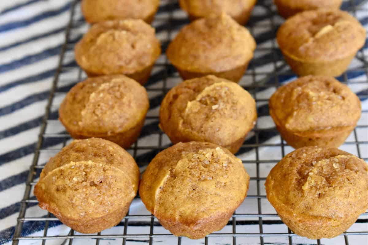 Mini pumpkin muffins on a wire cooling rack. 
